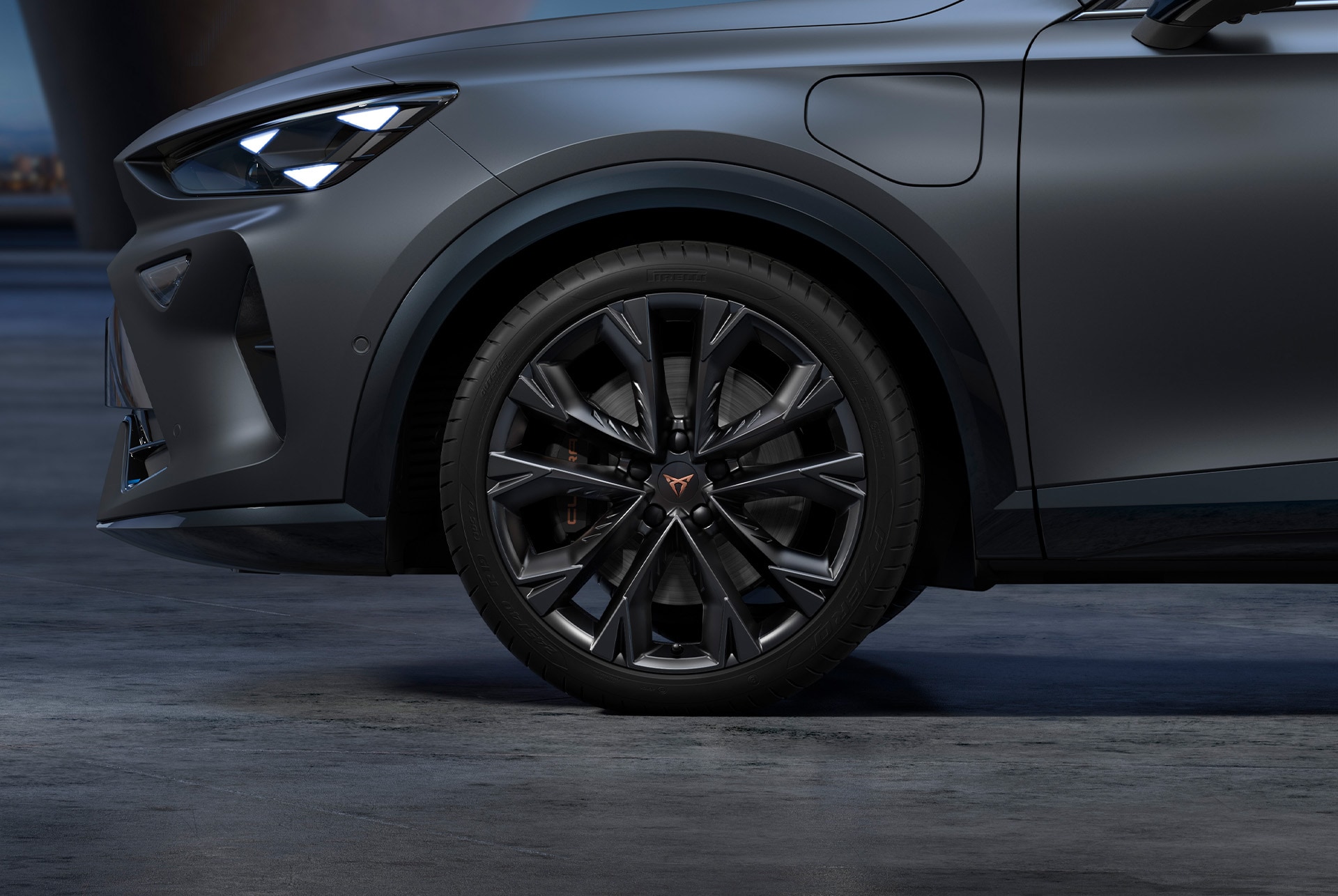 Front side view of left forged CUPRA in Sport black car wheels, tyres and signature headlights from the Black Edition.